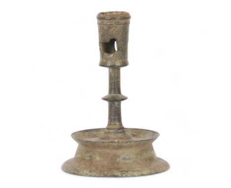 Early 15th century Netherlandish brass candlestick, the nozzle with pierced ejector holes upon a knopped stem and dished and 