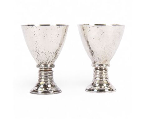 Pair of 20th century Greek silver metal goblets, each with planished tapering bowl upon a knopped stem and stepped spreading 