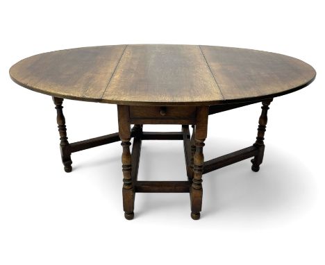18th century oak dining table, oval drop-leaf top on gate-leg action base, turned supports united by turned stretchers, fitte