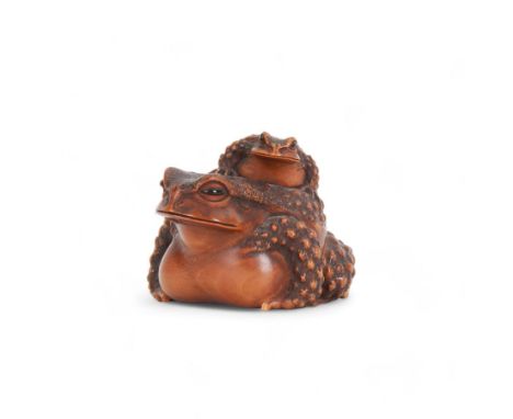 Japanese Edo Meiji period carved wooden netsuke, naturalistically modelled in the form of a seated toad with young upon its b