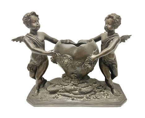 Late 19th century bronze jardinière, the planter of shaped ovoid form decorated with rose heads upon a naturalistic base mode