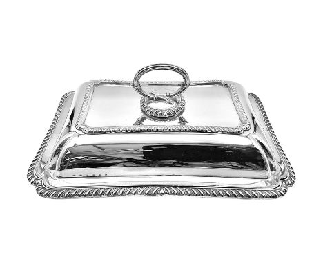 Early 20th century silver entree dish and cover, of rectangular form with shaped corners and oblique gadrooned borders to bas