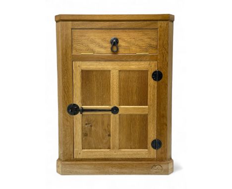 Mouseman - oak floor standing corner cupboard, fall front compartment over single panelled door, with wrought metal loop hand