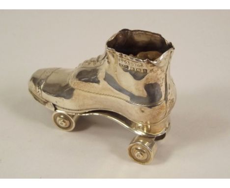 PIN CUSHION. A silver roller skating boot pin cushion with rotating wheels, Birmingham 1910. Rd. No. 535766, maker's mark for