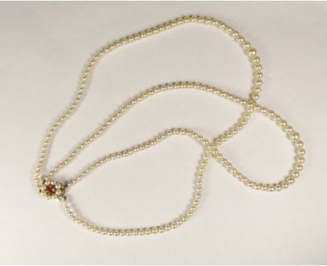 CULTURED PEARLS. A double strand cultured pearl necklace with 9ct. gold pearl set clasp.