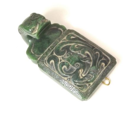JADE BUCKLE. One half of a 19th century spinach jade buckle, carved with dragons. 9 x 5cm.