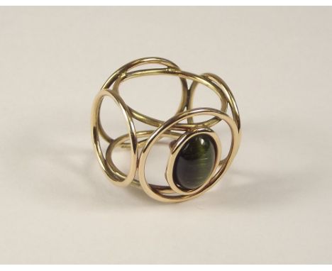 CAT'S EYE RING. A 1970's 9ct. gold cat's eye tourmaline ring, of unusual design.