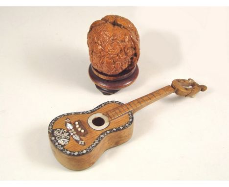 MISCELLANEOUS. A tortoiseshell &amp; mother of pearl inlaid miniature guitar (a.f.), 18cm, &amp; a moulded walnut, cast with 