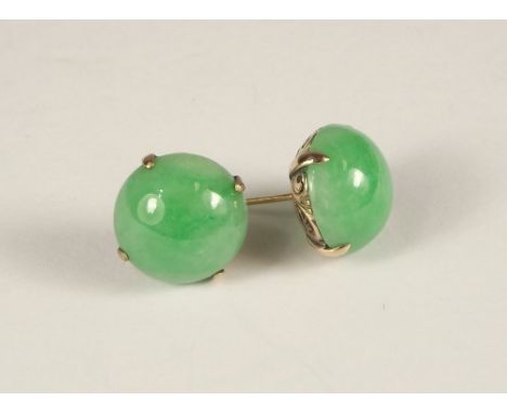 JADE EARRINGS. A pair of yellow metal mounted celadon green jade earrings. Diameter 1.4cm.