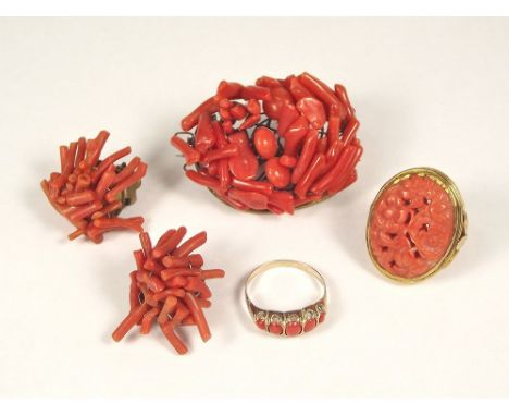 CORAL. A 9ct. gold mounted carved coral ring, one other 9ct. gold coral set ring, a stick coral brooch &amp; similar ear clip