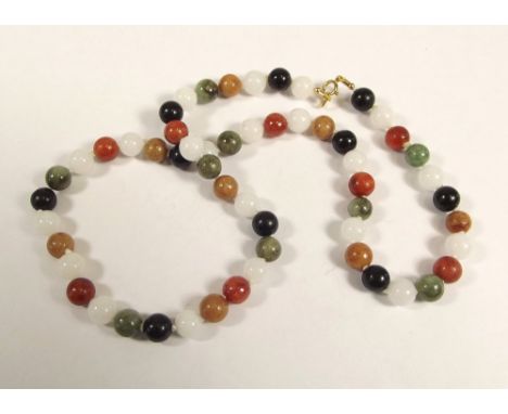 JADE NECKLACE. A coloured jade bead necklace with 9ct. gold clasp. Each bead 7mm. Length 48cm.