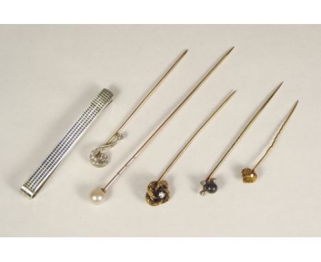 STICK PINS ETC. Three stick pins including gem-set, a hat pin &amp; a silver tie clip etc.