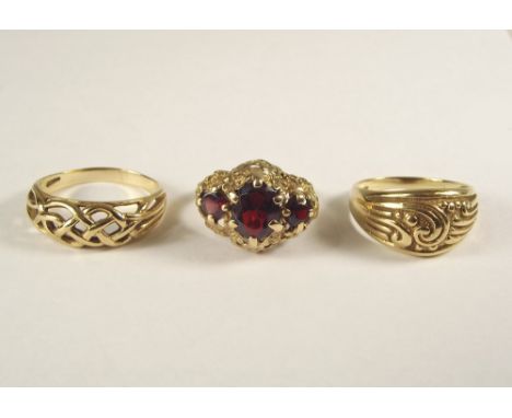 GOLD RINGS. A large 9ct. gold &amp; garnet dress ring &amp; two other 9ct. gold rings. Approx. 14.6g.