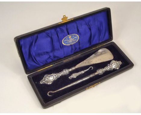 SHOE SET. A three piece, silver mounted button hook &amp; shoe lift set.