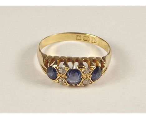 SAPPHIRE RING. An early 20th century 18ct. gold sapphire &amp; diamond ring. Size N.