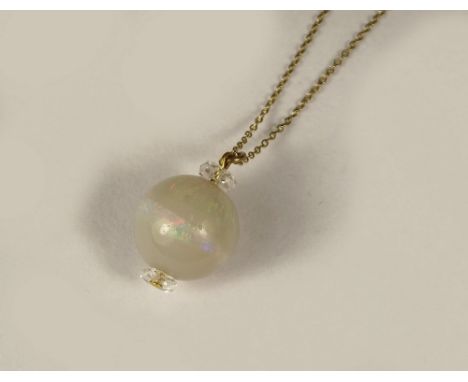 OPAL PENDANT. A 9ct, gold mounted, spherical opal &amp; crystal pendant, the opal of approx. 15ct. 9ct. gold trace chain.