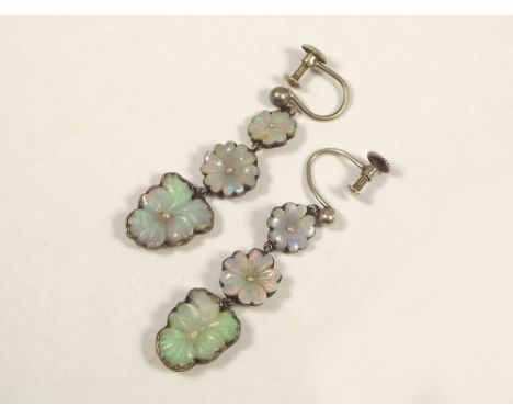 OPAL EARRINGS.
An unusual pair of white metal mounted, carved opal & seed pearl drop earrings with closed backs. Length 4cm.