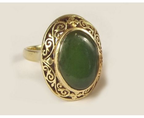 JADE RING. An 18k. &amp; spinach jade ring. Approx. 6.3g. Size L.
