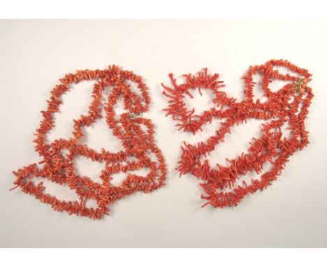 CORAL.
A stick coral, three strand necklace with coral set clasp & one other triple strand coral necklace.