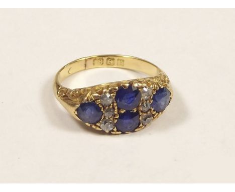 SAPPHIRE RING. An Edwardian, 18ct. gold sapphire &amp; diamond ring. Size K.