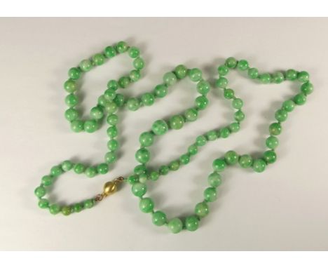 JADE BEADS. A rope of pale green graduated jade beads, with 9ct. gold clasp. Length approx. 82cm.