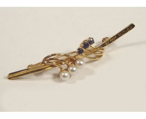 PEARL BROOCH. A 14k. pearl &amp; sapphire bar brooch with inscriptions.