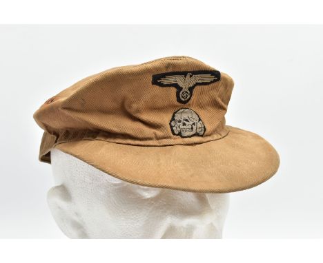 A THIRD REICH WORLD WAR TWO PERIOD SS TROPICAL FIELD CAP, in Sand with correct Deaths Head Skull and Eagle Insignia, the cap 