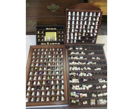 Three-thimble collection with display shelves mainly from The Thimble Collectors Club with a set of Hummel school children th