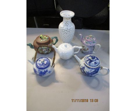 An 18th century blue and white Chinese teapot and four other teapots, together with a modern pierced Chinese vase 