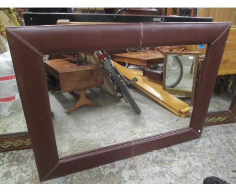 A modern brown leather framed wall hanging mirror, 33 1/4"h x 45"w 