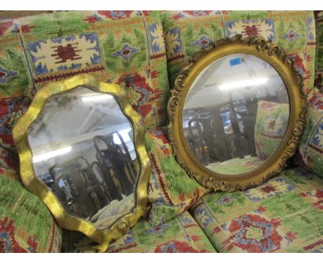 A circular gilt wall mirror and a gilt dressing table mirror on stand 