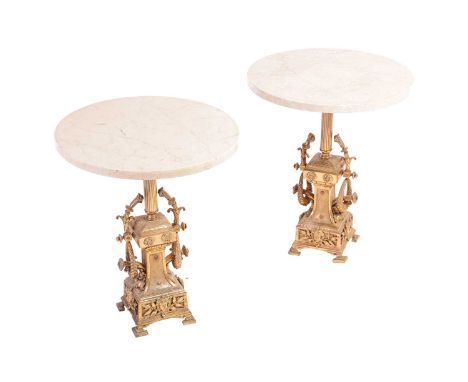 A pair of Louis XVI-style gilt bronze and marble lamp/urn tables.20th century, with circular marble tops over reeded columns 