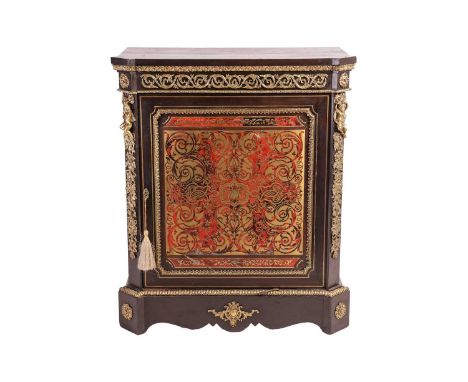 A Napoleon III ebonised and red Boule single-door pier cabinet, the door with a decorative inlaid panel flanked by figural mo