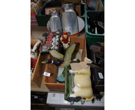 A box of cast iron doorstops, enamel bowl and two small milk churns.