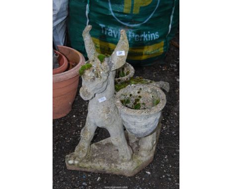 A concrete donkey planter
