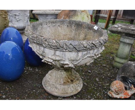 A concrete planter 21" diameter x 18" high.
