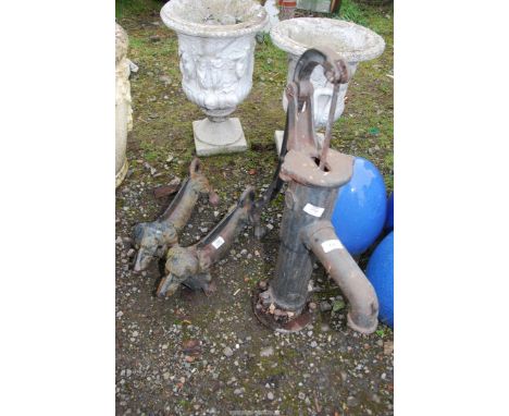 A Vintage water pump and a pair of boot scrapers.
