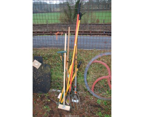 A quantity of garden tools, forks, lawn edgers, etc.