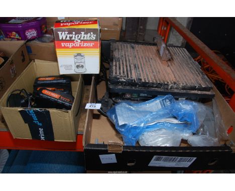 A tile cutter and spare batteries for drill, etc.