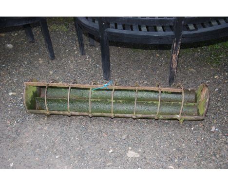 A cast iron pig trough, 4' long x 1'.
