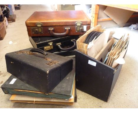 A brown leather briefcase and two others, plus various gramophone records.