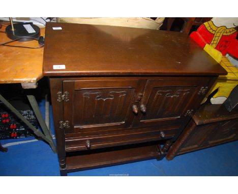 An Oak linen fold drinks cabinet, 31" wide x 16" depth x 33 1/2" high.