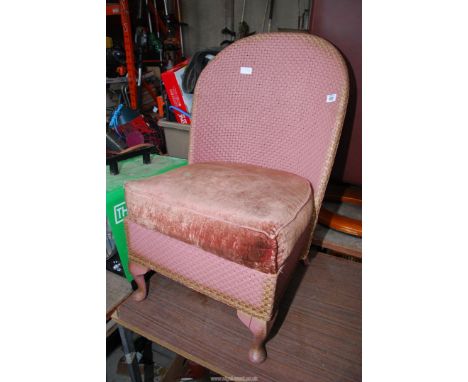 A pink Lloyd loom style chair.