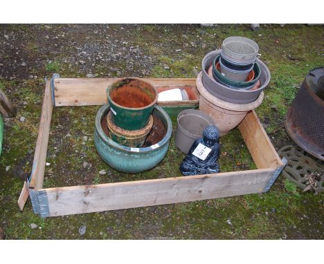 Glazed and terracotta pots, plastic planter, Buddha, etc plus a raised bed.