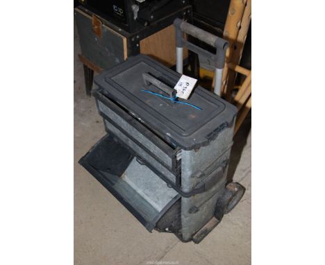 A portable tool chest with some contents.