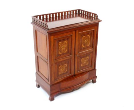 A late Victorian mahogany side cabinet, the rectangular top with a pierced three quarter gallery over a pair of twin panel ge