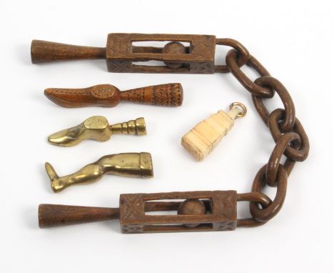 Five 19th Century pipe tampers comprising a late 18th Century wooden example with five link chain uniting a pair of tampers e