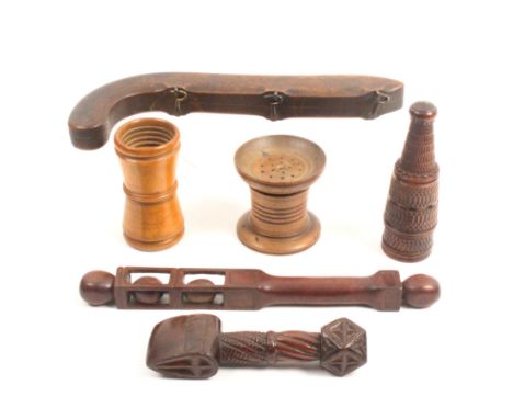 Six pieces of 19th Century treen comprising a hinged beech wood box in the form of a pistol, three hook form catches, 28cm, a