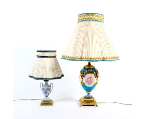 Two table lamps comprising a Minton style porcelain example the turquoise ground with four panels of cherubs, musical instrum