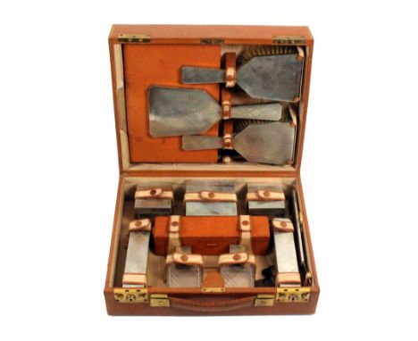 A pigskin silver fitted rectangular travel case by Asprey and Co Ltd, rectangular with twin locks, the silver fittings compri